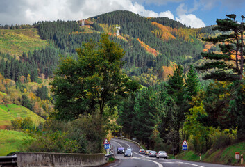 Travel by car in Spain. Green Hills, forests and road