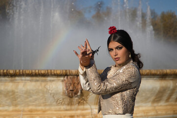 Portrait of young flamenco woman, Hispanic and brunette, with typical flamenco dance suit, with...