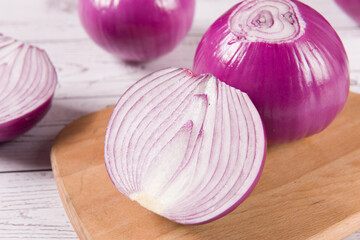 Red Onion and cut half on wooden background