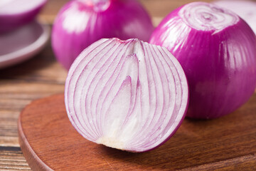 Red Onion and cut half on wooden background