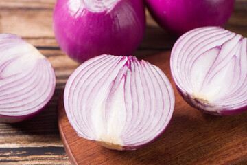 Red Onion and cut half on wooden background