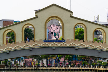 Old bus station bridge over the river Melaka in Melaka, Malaysia. - obrazy, fototapety, plakaty