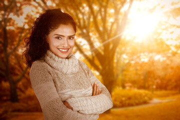 Confident young woman standing at autumn park