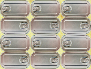 Obraz premium Close up of canning tins on yellow background.