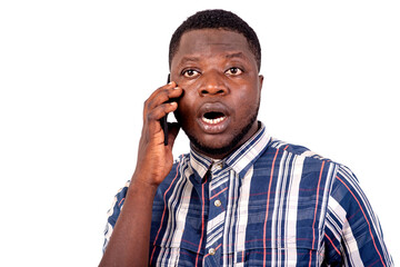 close-up of a young man talking on the cellphone, surprised.