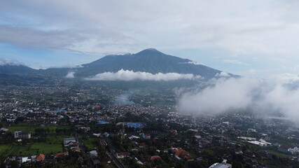 Drone shot of mountain in Batu City, Indonesia surrounded with clouds