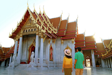 Fototapeta premium Couple Visiting The Marble Temple or Wat Benchamabophit, One of the Best-known Temples in Bangkok, Thailand