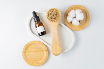 Cosmetic product and natural bristle wooden facial cleansing brush. Accessories for beauty treatments, facial cleansing brush on white background. Cosmetics products for face care. Unbranded mockup