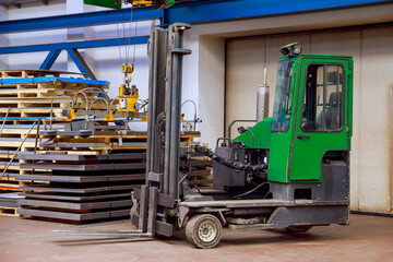 Multi-directional forklift at a metallurgical plant for loading pallets with sheet metal. Combilift.