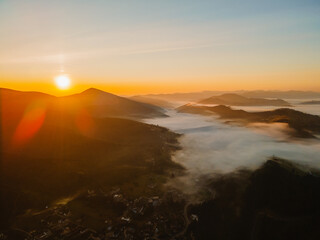 aerial view of sunrise above mountain range