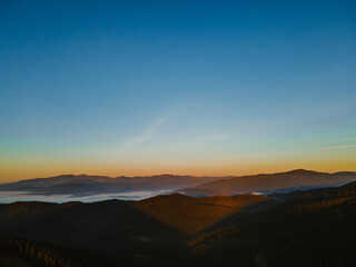 aerial view of sunrise above mountain range