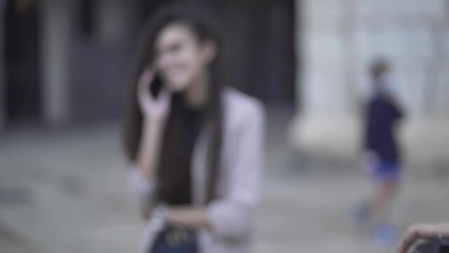 Photographer Taking Pictures On Girl Talking On The Phone. - rack focus