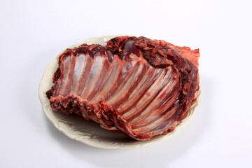 Raw deer ribs on a white plate, white background. Meat of wild animals.
Raw spare ribs on white background 