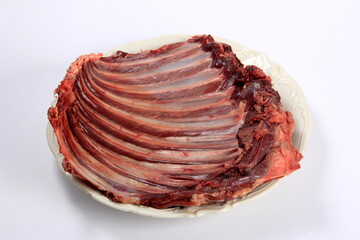 Raw deer ribs on a white plate, white background. Meat of wild animals.
Raw spare ribs on white...