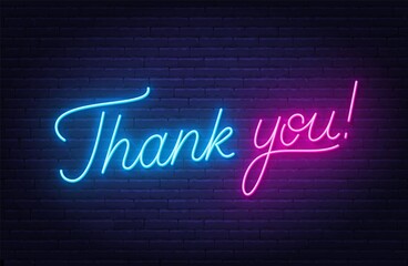 Thank you neon sign on brick wall background.
