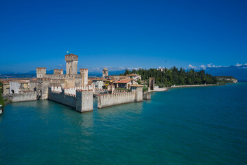 Fototapeta premium Aerial view on Sirmione sul Garda. Italy, Lombardy.Tourist destination in Lombardy region of Italy. Rocca Scaligera Castle in Sirmione. Aerial photography with drone.
