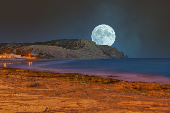 Full moon over the coast of Praia da Luz in the Algarve