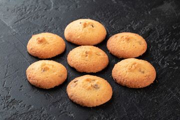 Healthy food concept. Homemade organic energy cookies on black slate stone background with copy space