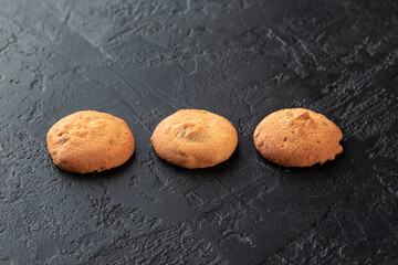 Healthy food concept. Homemade organic energy cookies on black slate stone background with copy space