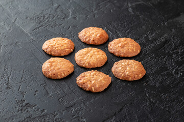 Healthy food concept. Homemade organic energy cookies on black slate stone background with copy space