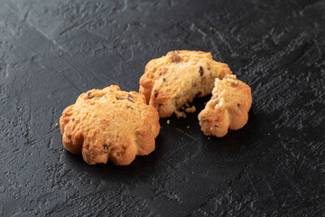 Healthy food concept. Homemade organic energy cookies on black slate stone background with copy space