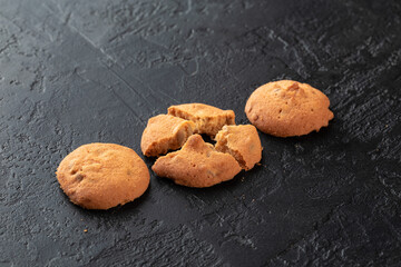 Healthy food concept. Homemade organic energy cookies on black slate stone background with copy space