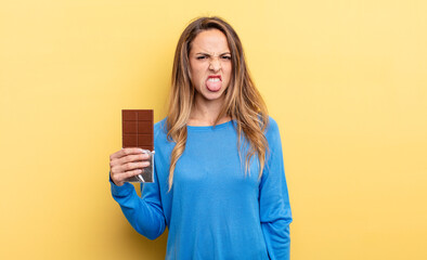 pretty woman feeling disgusted and irritated and tongue out. chocolate concept