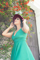 Beautiful girl with hat and dress walking down the street