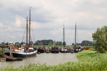 Old houseboats in the historic harbor of the old fortified town of Woudrichem.