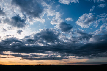 late evening, beautiful sunset sky with floating clouds