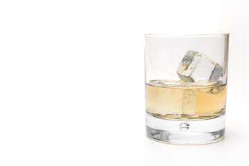 filled whiskey glass ice cubes white background