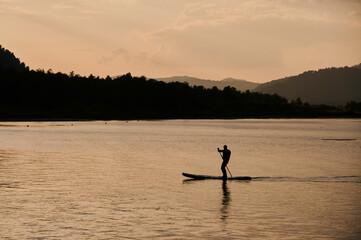 Active leisure in summer lifestyle. A boy rides on the sea in a sap. Concept of solitude, outdoor...