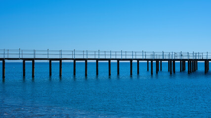 a pier on the beach and calming sea views
