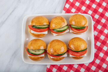 Mini Sandwiches with Cheddar Cheese, Tomato, Cucumber and Cream Cheese. Snacks for parties and...