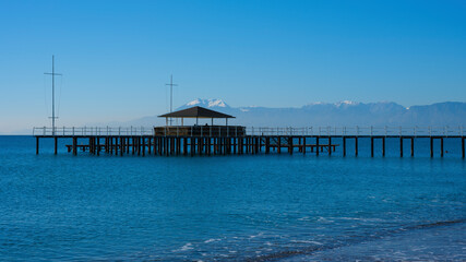 Obraz premium a pier on the beach and calming sea views