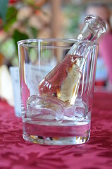 A shot of rakija (fruit brandy) cooling in a glass of ice