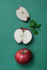 Creative layout from an apple on a green background. Flat lay. Food concept.