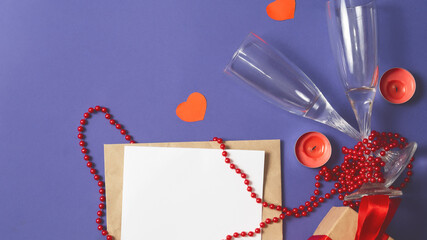 Valentine's day. two glasses, envelope with sheet blank, hearts, candles on Very Peri, Trendy violet color background. Romantic dinner couple concept. flat lay. top view