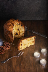 Pannetone with raisins on wooden table