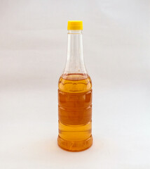 Little apple cider vinegar in a transparent bottle stands in the background. Selective focus. Space for text.  