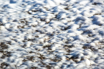 As waves break on a Suffolk Beach