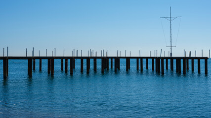Fototapeta na wymiar a pier on the beach and calming sea views