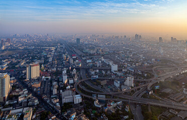 Naklejka na ściany i meble Dawn over Bangkok. At the height of a bird's flight. Smog hell city. 