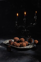 Dark chocolate truffle on dark background