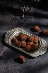 Dark chocolate truffle on dark background