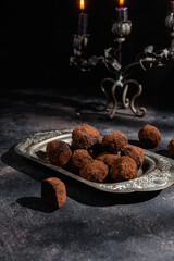 Dark chocolate truffle on dark background