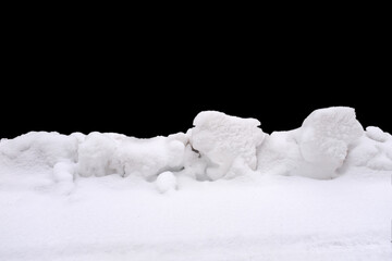 a pile of snow isolated against a black background