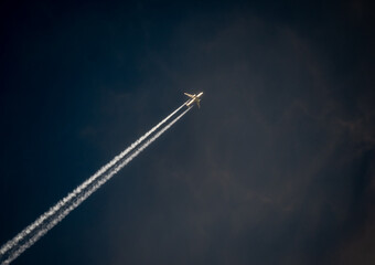 Contrail of overflying passenger airplane. Traces left by the plane in the sky