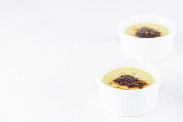 Creme brulee with blueberries in bowls on a table. Horizontal orientation, copy space.