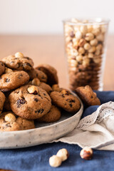 Aromatic homemade cookies with nuts, chocolate and raisins. An example of serving on a plate.